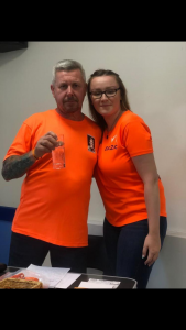 man and woman in orange t-shirts